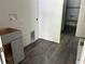 Laundry room with hookups, gray cabinets and wood-look flooring at 8149 Cashew, Webster, FL 33597