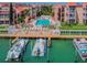 An aerial view of the condo buildings, pool, boat docks, and waterfront area of this lovely community at 8931 Blind Pass Rd # 257, St Pete Beach, FL 33706