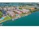 Aerial view of a waterfront condo community, marina, and swimming pool, offering a resort-style living experience at 8931 Blind Pass Rd # 257, St Pete Beach, FL 33706