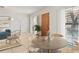Bright dining area featuring a round table, modern decor, and natural light, enhancing the inviting atmosphere at 8931 Blind Pass Rd # 257, St Pete Beach, FL 33706