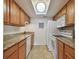 Efficient kitchen featuring granite countertops, tile flooring, and white appliances, ready for culinary exploration at 8931 Blind Pass Rd # 257, St Pete Beach, FL 33706