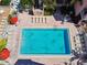 Overhead view of a pristine blue pool with lounge chairs and umbrellas, offering relaxation and recreation at 8931 Blind Pass Rd # 257, St Pete Beach, FL 33706