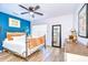 Charming bedroom with blue accent wall, a decorative bed frame, and ample natural light at 9304 Lake Chase Island Way, Tampa, FL 33626