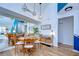 Bright dining room with modern lighting, a large mirror, and a stylish table setting at 9304 Lake Chase Island Way, Tampa, FL 33626