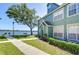 Charming condo with lush front lawn, lake view and sidewalk entrance at 9304 Lake Chase Island Way, Tampa, FL 33626
