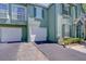 Unit exterior with multiple garages and shutters at 9304 Lake Chase Island Way, Tampa, FL 33626