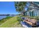 Exterior view with benches facing a lake with a fountain at 9304 Lake Chase Island Way, Tampa, FL 33626