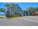 Inviting home exterior featuring lush landscaping, ample parking and a serene waterfront view at 9304 Lake Chase Island Way, Tampa, FL 33626