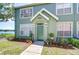 Charming home featuring a welcoming front door, complemented by an array of colorful potted plants at 9304 Lake Chase Island Way, Tampa, FL 33626