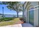 Charming lakefront home entrance with inviting green door and well-manicured landscaping near the water at 9304 Lake Chase Island Way, Tampa, FL 33626