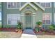 Home featuring a welcoming front door with colorful potted plants and neutral accents at 9304 Lake Chase Island Way, Tampa, FL 33626