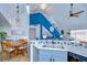 Open concept kitchen features marble countertops and views of the custom stairway at 9304 Lake Chase Island Way, Tampa, FL 33626