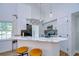 Bright kitchen features a marble countertop bar, stainless steel appliances, and pendant lighting at 9304 Lake Chase Island Way, Tampa, FL 33626