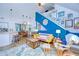 Bright living room featuring a blue accent wall, decorative furniture and open access to dining and kitchen at 9304 Lake Chase Island Way, Tampa, FL 33626