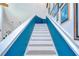 Bright stairway with blue accent wall and white trim at 9304 Lake Chase Island Way, Tampa, FL 33626