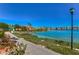 Waterfront view of buildings and a walking path along the water at 9304 Lake Chase Island Way, Tampa, FL 33626