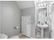 Half bathroom with a toilet, a pedestal sink, and a framed mirror at 9628 Charlesberg Dr, Tampa, FL 33635