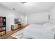 Bright bedroom with a modern bed, white walls, and a television on the furniture at 9628 Charlesberg Dr, Tampa, FL 33635