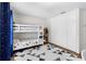 bedroom with a bunk bed, closet, and a triangle pattern rug at 9628 Charlesberg Dr, Tampa, FL 33635