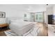 Bright bedroom with a modern bed, white walls, and a large window bringing in natural light at 9628 Charlesberg Dr, Tampa, FL 33635