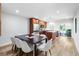 Well-lit dining room with a modern table, seating for six, and an open kitchen concept at 9628 Charlesberg Dr, Tampa, FL 33635