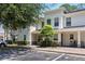 Well-maintained townhouse with assigned parking, landscaping, and a private, covered entryway at 9628 Charlesberg Dr, Tampa, FL 33635