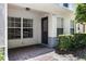 Inviting entrance with a brick-paved patio, featuring a modern door, window, and manicured landscaping at 9628 Charlesberg Dr, Tampa, FL 33635