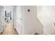 Hallway view with hardwood floors and access to a room with a work desk and window at 9628 Charlesberg Dr, Tampa, FL 33635