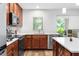Bright kitchen featuring stainless steel appliances, wood cabinets, island, and a window with natural light at 9628 Charlesberg Dr, Tampa, FL 33635