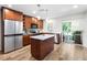 Modern kitchen with stainless steel appliances, a center island, and a view to outdoor living space at 9628 Charlesberg Dr, Tampa, FL 33635