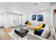 Inviting living room featuring hardwood floors, a comfortable sofa, and bright natural light at 9628 Charlesberg Dr, Tampa, FL 33635