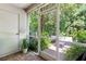Inviting screened porch with views of a lush, green backyard and a comfortable seating area at 9628 Charlesberg Dr, Tampa, FL 33635
