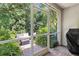 Charming screened porch with views of a lush, green backyard and a comfortable seating area at 9628 Charlesberg Dr, Tampa, FL 33635