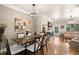 Inviting dining area flowing into a living room with hardwood floors at 9727 Tiffany Oaks Ln, Tampa, FL 33612