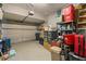 Spacious garage with overhead door, storage shelves, and room for parking and projects at 9727 Tiffany Oaks Ln, Tampa, FL 33612