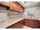 Stylish kitchen showcasing granite counters, updated appliances, and lake views at 9727 Tiffany Oaks Ln, Tampa, FL 33612