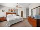 The Main bedroom has an elegant ceiling fan, a large wooden dresser, and neutral walls at 9727 Tiffany Oaks Ln, Tampa, FL 33612