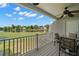 Relaxing covered patio with lake view, outdoor furniture and ceiling fan at 9727 Tiffany Oaks Ln, Tampa, FL 33612