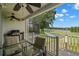 Enjoy outdoor dining on this screened patio with ceiling fan, a grill and serene lake views at 9727 Tiffany Oaks Ln, Tampa, FL 33612