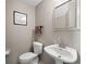 Powder room features a neutral color scheme, pedestal sink, and framed mirror at 9727 Tiffany Oaks Ln, Tampa, FL 33612