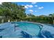 Enjoy the community pool surrounded by lush greenery and comfortable lounge chairs at 9727 Tiffany Oaks Ln, Tampa, FL 33612
