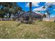 Private backyard with a screened-in pool and lush lawn, creating a serene outdoor oasis for relaxation and recreation at 9730 Reynosa Dr, New Port Richey, FL 34655