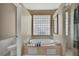 Relaxing bathroom featuring a soaking tub, shower, and toilet at 9730 Reynosa Dr, New Port Richey, FL 34655