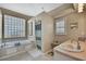 Well-lit bathroom with a soaking tub, shower, and ample counter space at 9730 Reynosa Dr, New Port Richey, FL 34655