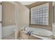 Bathroom featuring a soaking tub, shower, and toilet at 9730 Reynosa Dr, New Port Richey, FL 34655
