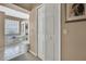 Hallway view of the bright bathroom featuring a tub and glass block window at 9730 Reynosa Dr, New Port Richey, FL 34655