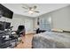 Cozy bedroom with wood-look flooring, ceiling fan and shuttered window for plenty of natural light at 9730 Reynosa Dr, New Port Richey, FL 34655