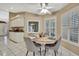 Cozy breakfast nook featuring bright windows, a ceiling fan, and a charming table setting at 9730 Reynosa Dr, New Port Richey, FL 34655