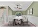 Elegant dining room featuring a marble table, six chairs, stylish fan, and decorative wall art at 9730 Reynosa Dr, New Port Richey, FL 34655