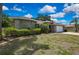 Charming single-story home features a well-manicured lawn, mature landscaping, and a welcoming brick facade at 9730 Reynosa Dr, New Port Richey, FL 34655